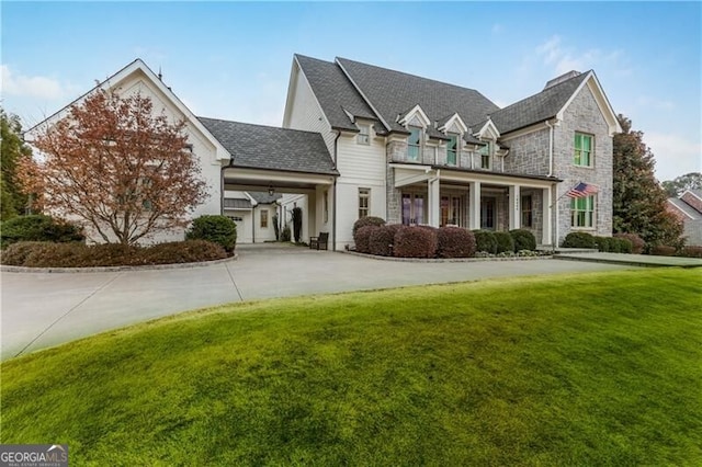 view of front of home with a front yard and a balcony