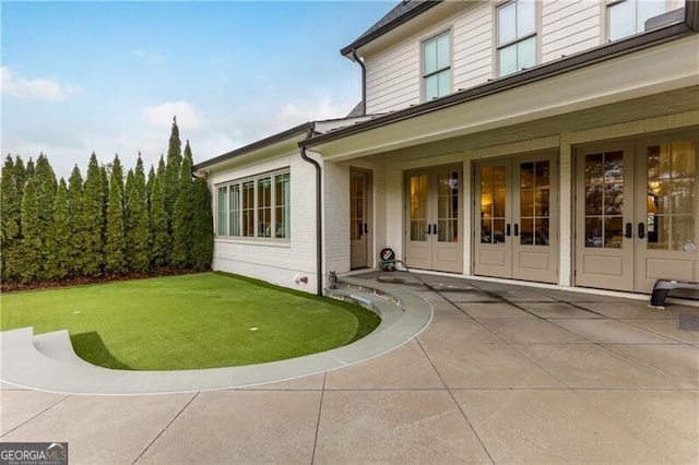 property entrance featuring a patio area and french doors