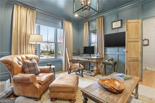 office space featuring a notable chandelier, wood-type flooring, and crown molding