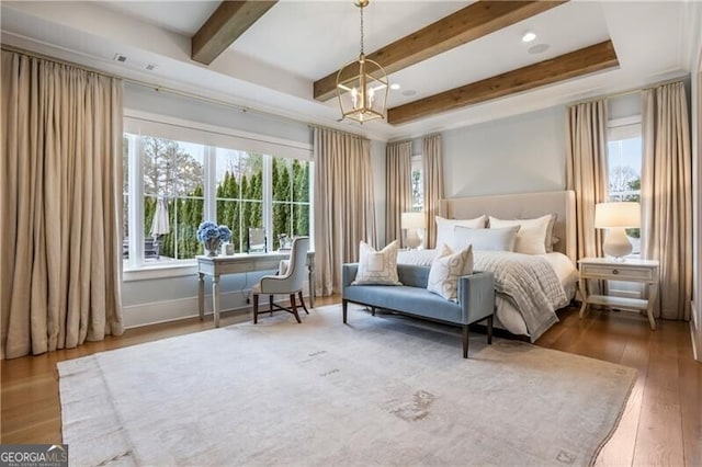 bedroom with a chandelier and hardwood / wood-style flooring