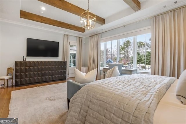 bedroom featuring beam ceiling, a chandelier, a tray ceiling, and wood-type flooring