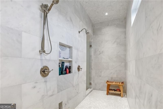 bathroom with a tile shower