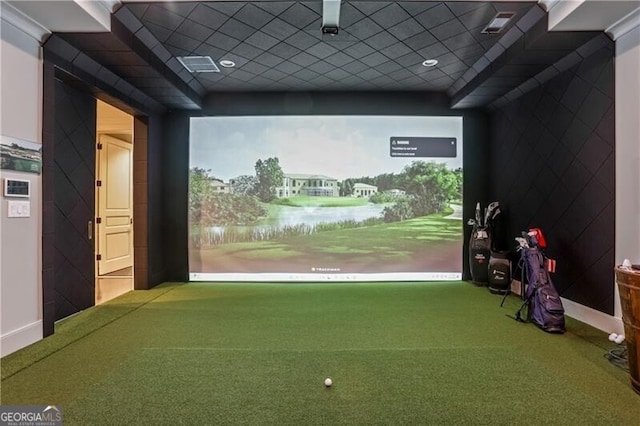 game room with carpet, a paneled ceiling, a water view, and golf simulator