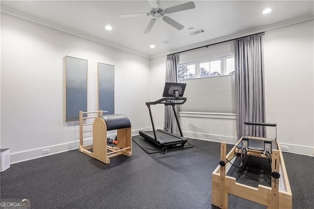 workout area featuring ceiling fan and crown molding