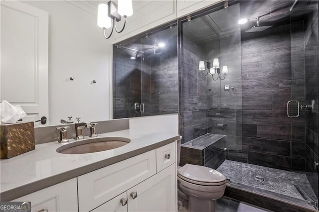 bathroom featuring an enclosed shower, vanity, and toilet