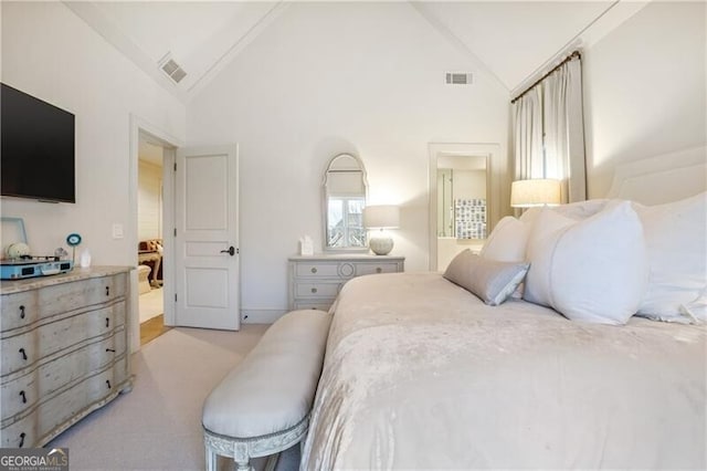 bedroom with high vaulted ceiling and light colored carpet