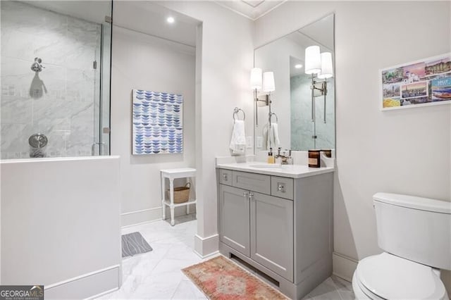 bathroom with vanity, toilet, and tiled shower