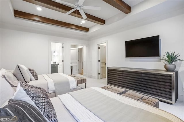 carpeted bedroom with beamed ceiling, ensuite bath, and ceiling fan