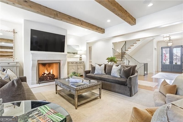 living room featuring light hardwood / wood-style flooring and beamed ceiling