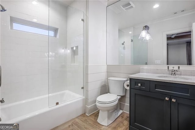 full bathroom featuring tub / shower combination, vanity, crown molding, hardwood / wood-style flooring, and toilet