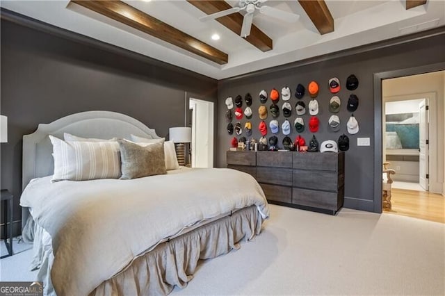 bedroom featuring beamed ceiling, ceiling fan, and ensuite bathroom