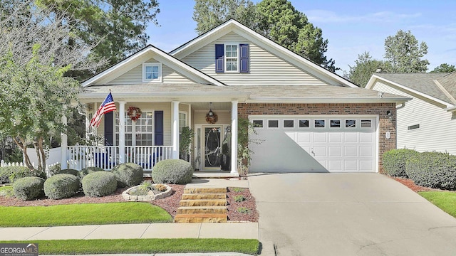 view of front of house with covered porch and a garage