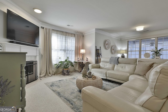 living room with light carpet, ornamental molding, and a tiled fireplace