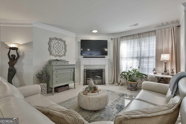 living room featuring carpet flooring, a tile fireplace, and crown molding