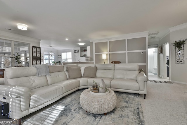 carpeted living room with crown molding and a notable chandelier