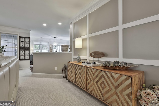 interior space featuring light colored carpet and crown molding