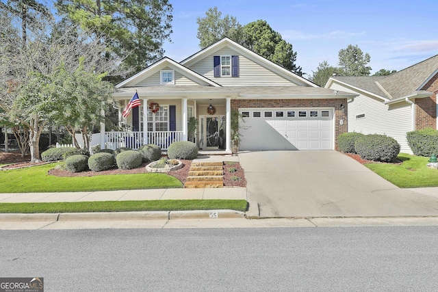 view of front of property featuring covered porch and a garage