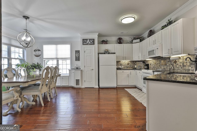 kitchen featuring sink, dark wood-type flooring, pendant lighting, white appliances, and white cabinets