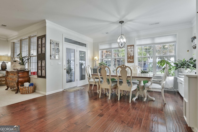 dining area with french doors, an inviting chandelier, plenty of natural light, and dark wood-type flooring