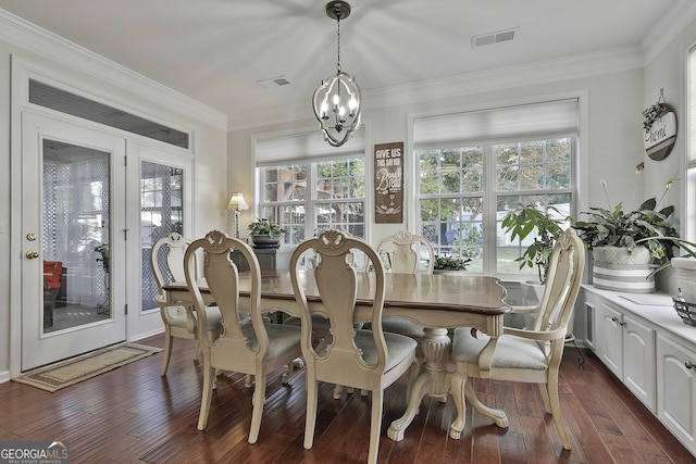 dining area with ornamental molding, dark hardwood / wood-style floors, and a notable chandelier