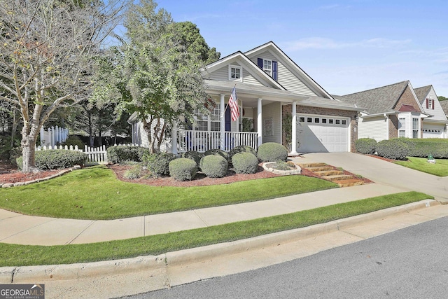 view of front facade featuring a front yard, a porch, and a garage