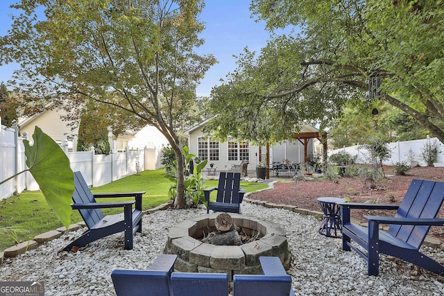 view of yard featuring a gazebo, a patio, and an outdoor fire pit