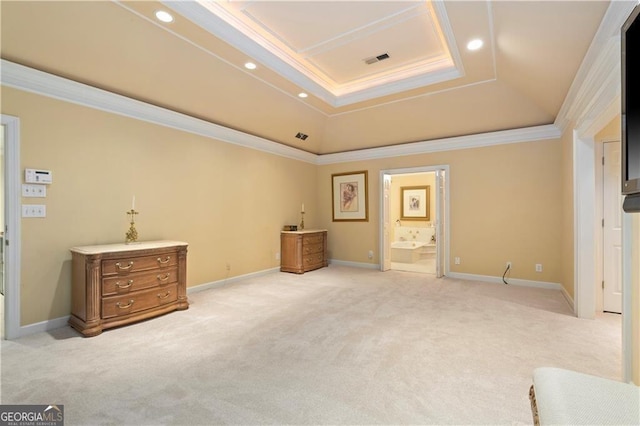 bedroom featuring light carpet, a raised ceiling, ensuite bath, and crown molding