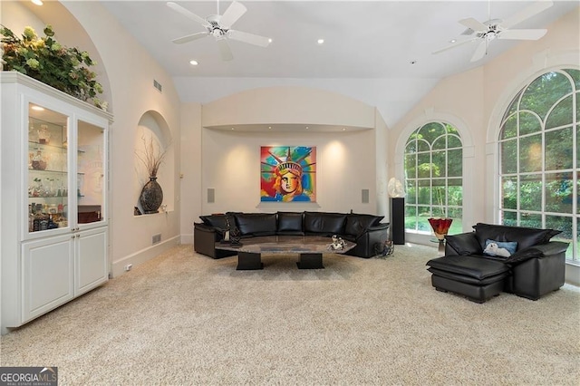 living room with ceiling fan, light carpet, and vaulted ceiling