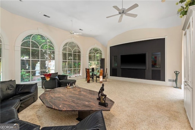 living room with a wealth of natural light, light carpet, and ceiling fan