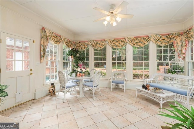 unfurnished sunroom with ceiling fan and a wealth of natural light