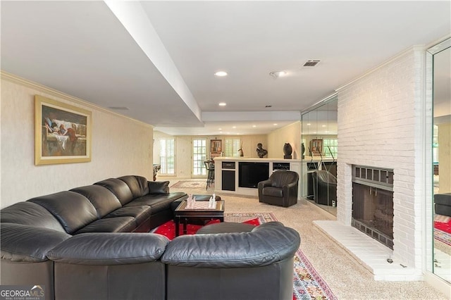 living room with a fireplace, light colored carpet, and ornamental molding