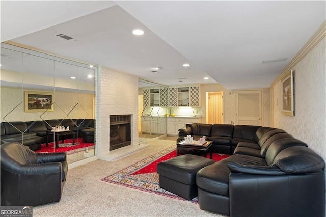 carpeted living room featuring a large fireplace and bar area