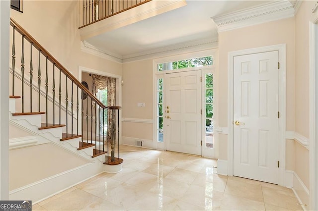 tiled foyer with crown molding