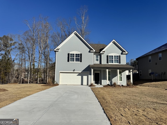 view of front of property with a garage, a front yard, and covered porch