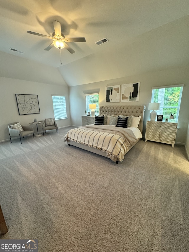 bedroom with ceiling fan, lofted ceiling, carpet flooring, and multiple windows