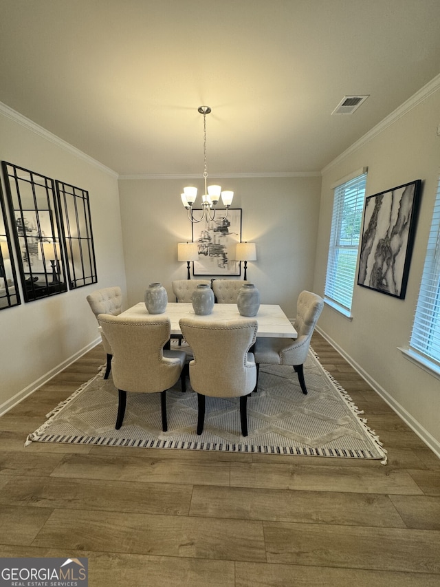 dining room featuring an inviting chandelier, wood-type flooring, and ornamental molding