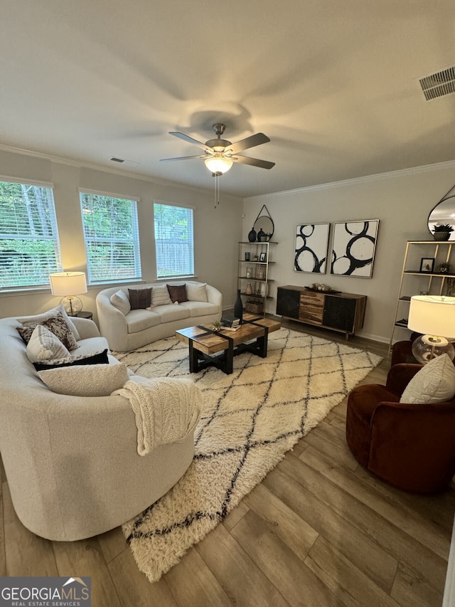 living room featuring crown molding, ceiling fan, and light hardwood / wood-style floors