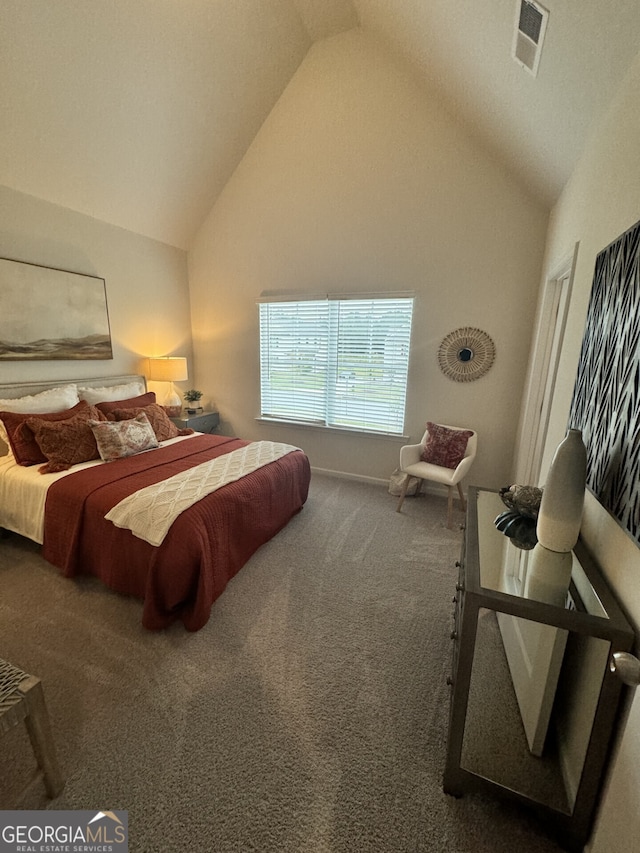 bedroom with high vaulted ceiling and dark colored carpet