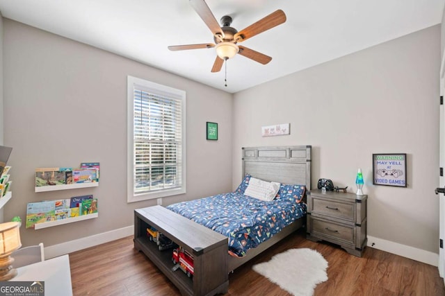 bedroom featuring hardwood / wood-style floors and ceiling fan