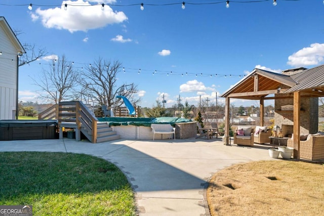 view of yard featuring an outdoor living space with a fireplace, a patio area, and a covered pool