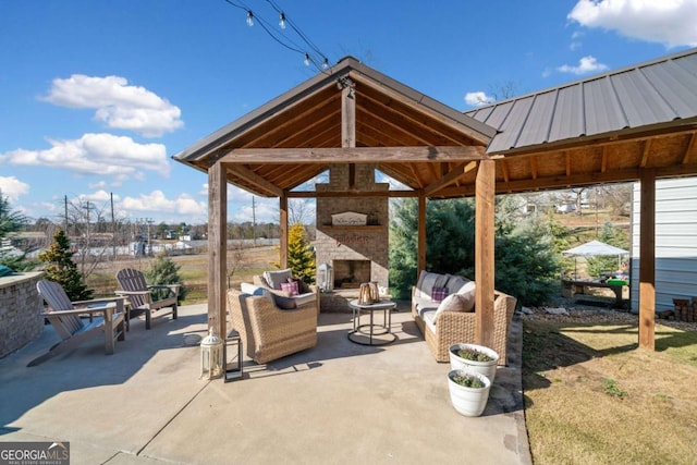 view of patio featuring a gazebo and an outdoor living space with a fireplace