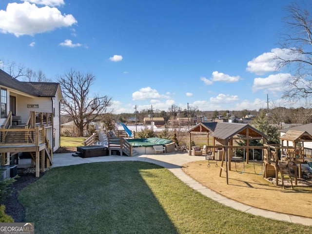 view of play area with a gazebo, a yard, and a pool with hot tub