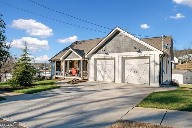 view of front of house featuring a front lawn, covered porch, and a garage