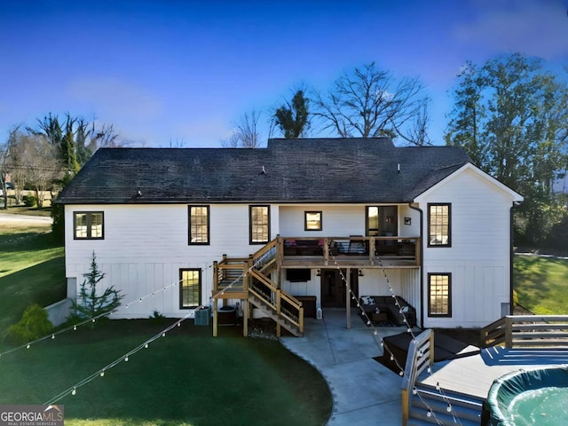 back of property featuring a yard, a patio, and a wooden deck