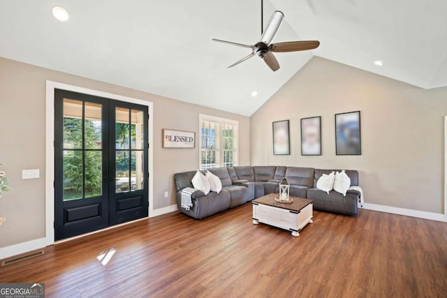 living room with hardwood / wood-style flooring, ceiling fan, lofted ceiling, and french doors