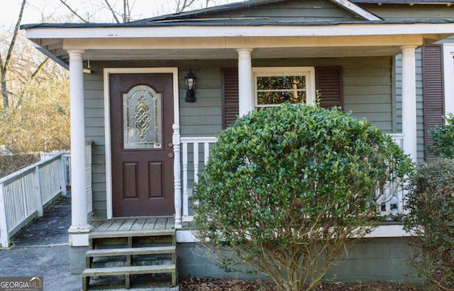 view of exterior entry featuring a porch