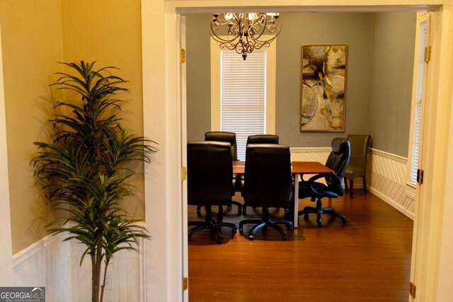 office space featuring hardwood / wood-style floors and an inviting chandelier