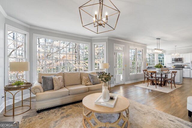 dining area with ornamental molding, a notable chandelier, and dark hardwood / wood-style floors