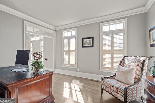 office area featuring ornamental molding and light hardwood / wood-style flooring