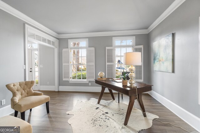 hall with ornamental molding, a notable chandelier, and hardwood / wood-style floors